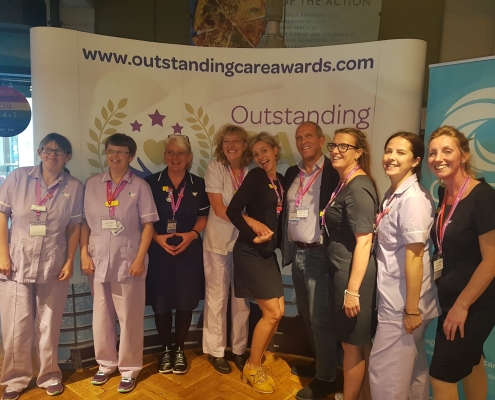 This image shows care staff at an awards event.